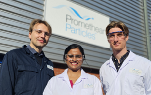 Three Promethean Particles staff members outside their manufacturing facility